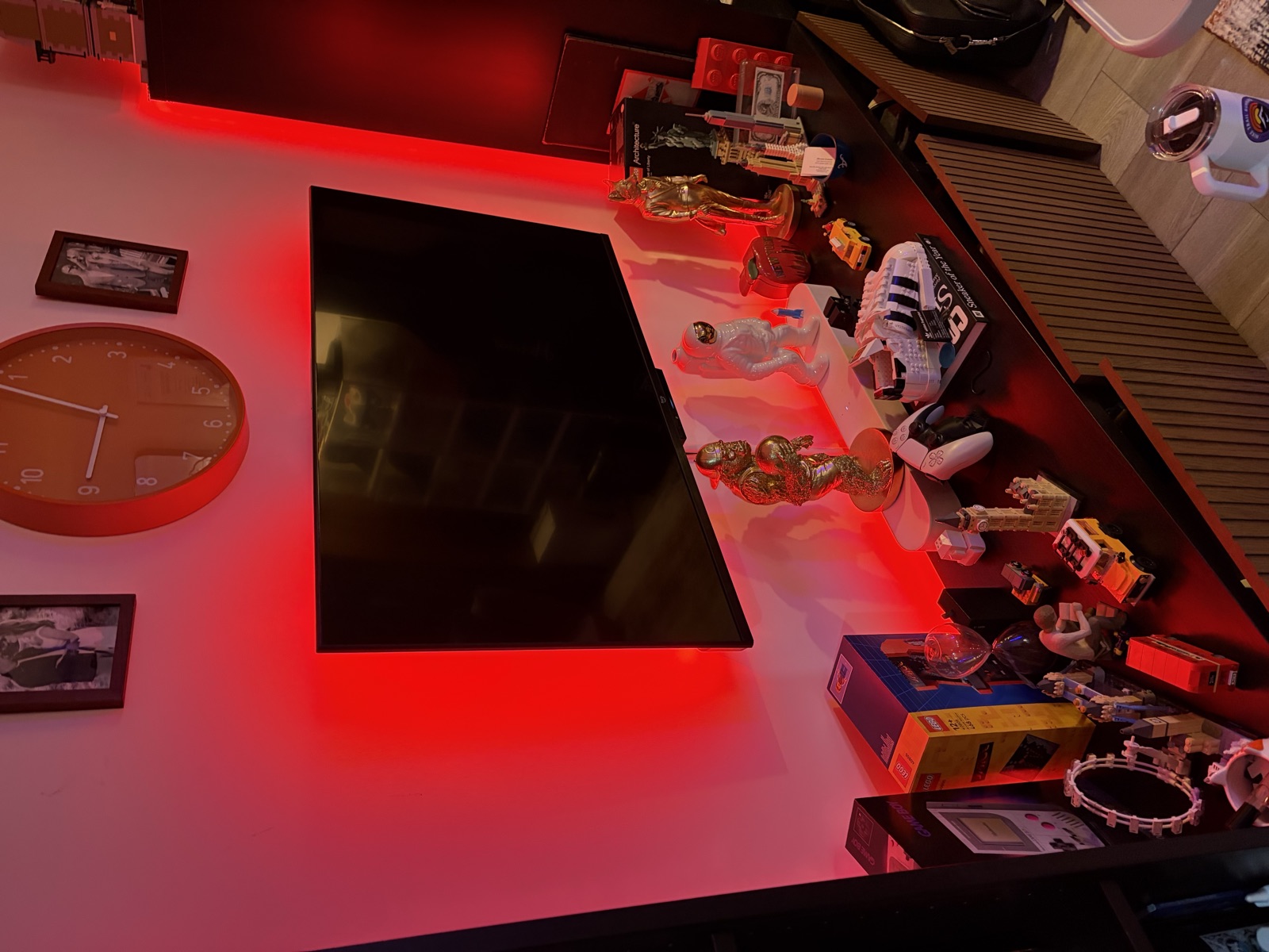 TV entertainment area with red LED backlighting, astronaut figurines, and collectibles